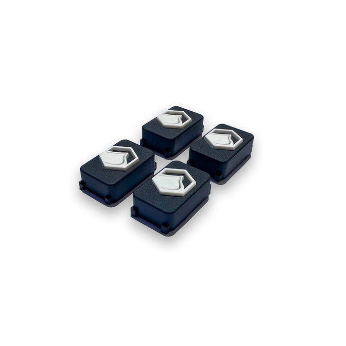 Angled Front View of Four black and white 4D FlexTrack Plugs, part of a hardware set for Liquid Force FlexTrack Wakeboards, on a white background.