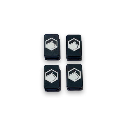 Top View of Four black and white 4D FlexTrack Plugs, part of a hardware set for Liquid Force FlexTrack Wakeboards, on a white background.